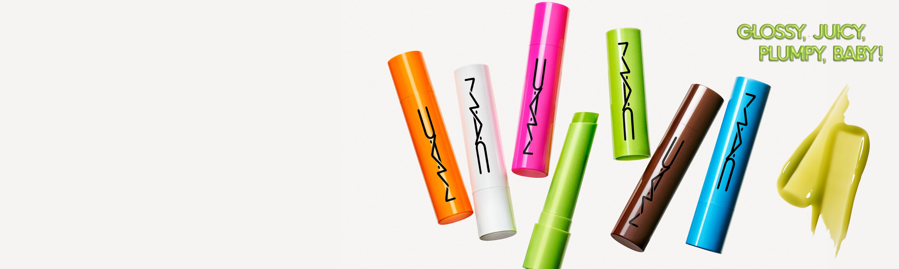 Group of lipsticks lying down on a grey background