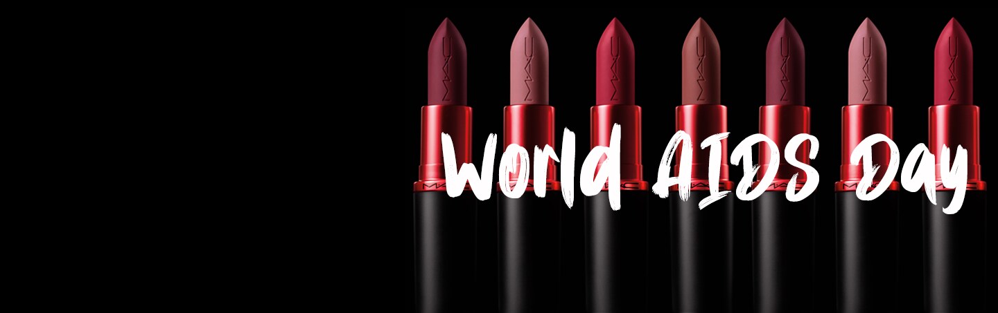 Group of lipsticks lying down on a grey background
